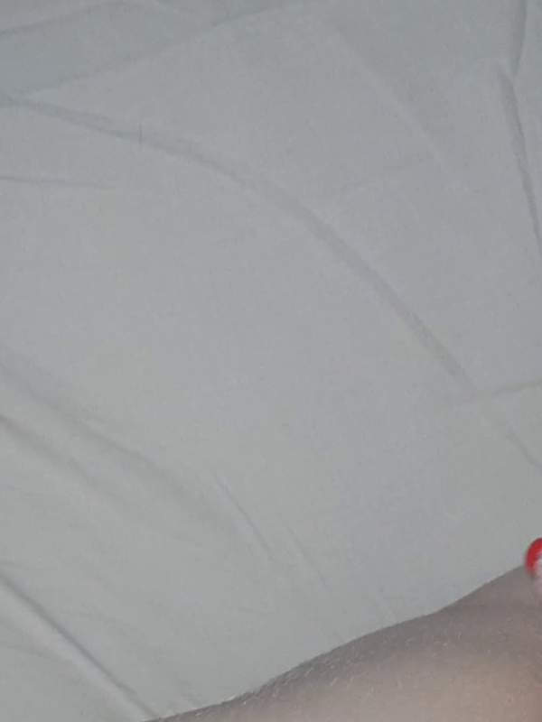 Amateur masturbates on bed with wet pussy