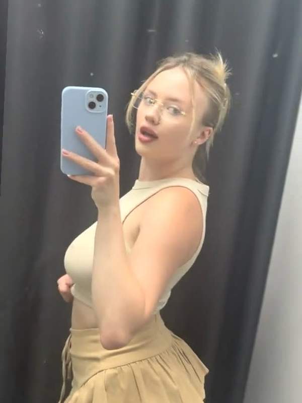 Blonde zeigt nackte Brüste in Röckchen