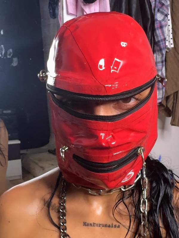 Brünette in Latex mit Maske und Kette