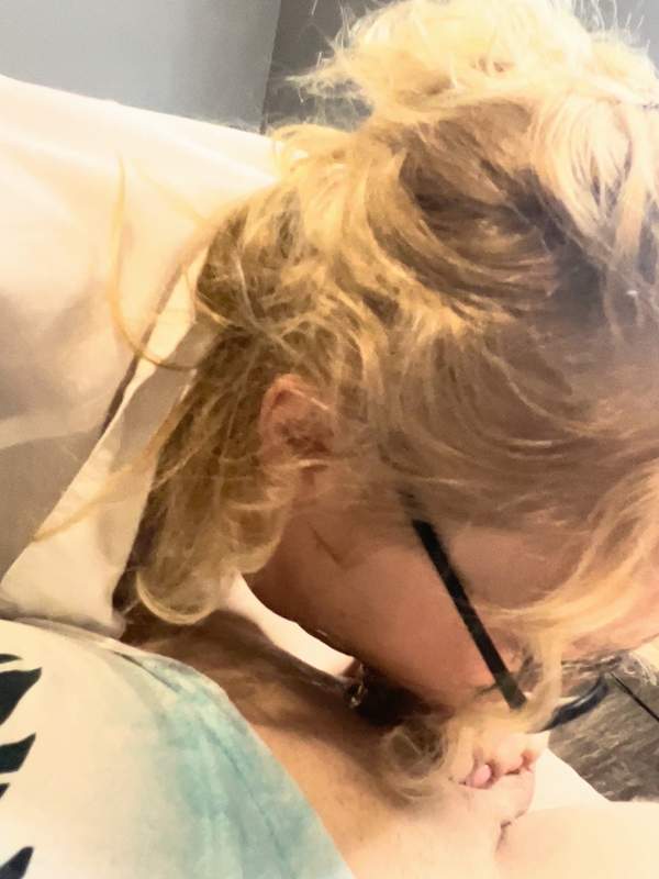 Blonde Frau mit Brille fängt tief in den Hals eines Paares an